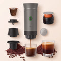 Cafetera Presura gris grafito con sus soportes, cápsulas y café molido